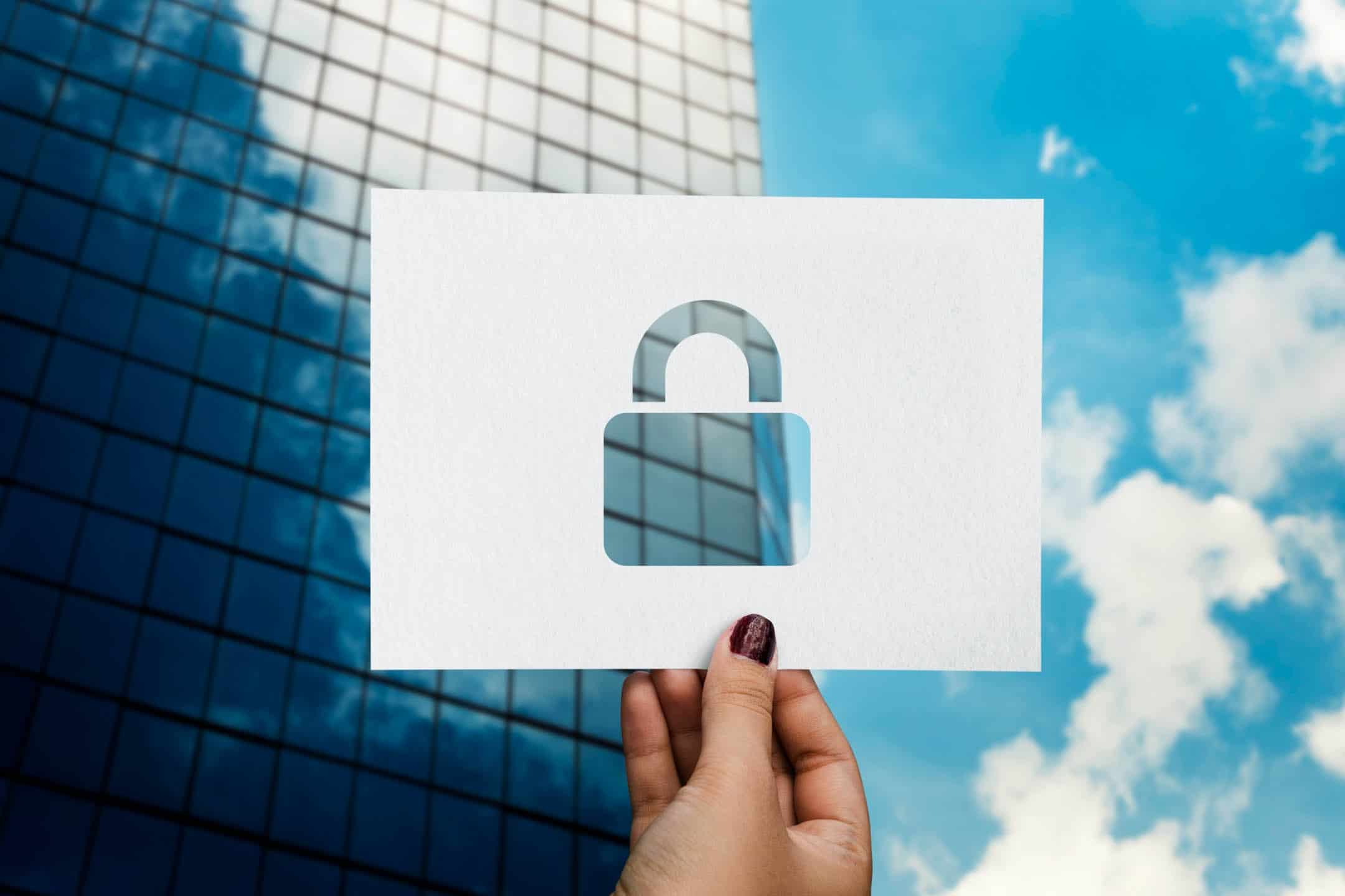 Secure modern office building with glass facade in the background.